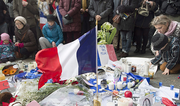 People attend a rally of solidarity outside the Consulate of France, in Montreal, on Sunday, Nov. 15, 2015, to show their support to the victims of the Paris attacks. THE CANADIAN PRESS/Graham Hughes